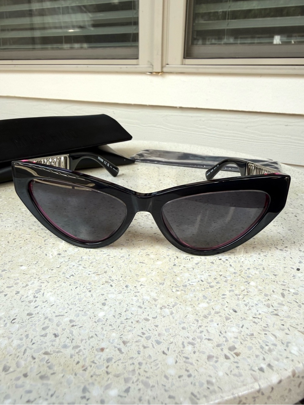 Moschino Black Cat-Eye Sunglasses with Subtle Pink Trim and Silver-Tone Hardware